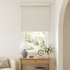 Light beige jacquard blackout roller shade with woven texture over window