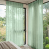 Custom Linden Linen Blend Sheer Curtain in soft green with garden view.